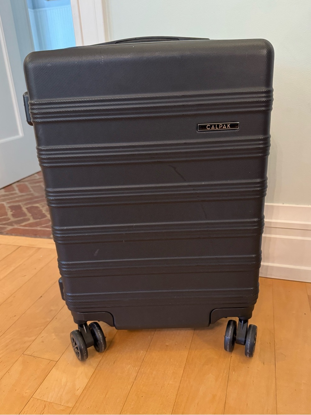 Calpak carry on size expandable hardshell suitcase luggage in black